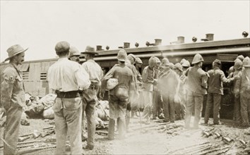 Loading a hospital train at Standerton. Uniformed British troops help to load up a hospital train