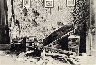 Effects of a Boer shell. A postcard illustrating the damage caused to the interior of a house by a