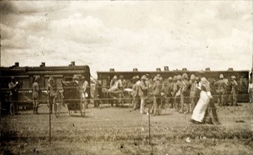 Hospital train at Standerton. A nurse passes a crowd of uniformed troops waiting beside a hospital