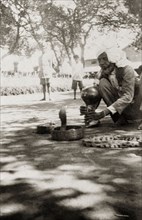 An Indian snake charmer at work. An Indian snake charmer plays a traditional bamboo 'pungi' as he