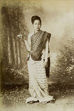Portrait of a Burmese lady. A posed studio portrait of a young Burmese woman, traditionally dressed