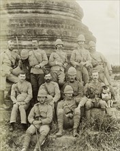 British Army officers in Wuntho. British Army officers pose informally at the the base of a carved