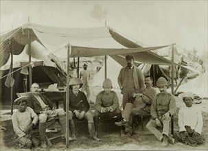 Civil Officers at Wuntho. Six British Civil Officers pose for the camera beneath the awning of a