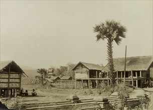 View of Wuntho, Burma (Myanmar). View of Wuntho showing dwellings with thatched roofs supported on