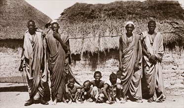 Bataheen men and children, Sudan. Four Sudanese men pose for the camera with four small children