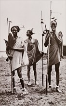 Portrait of three Shilluk warriors. Group portrait of three Shilluk warriors. Each man wears a