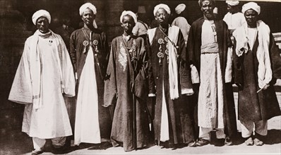 Six Gimma 'sheikhs'. Six Gimma 'sheikhs' pose for a group portrait. They wear traditional dress