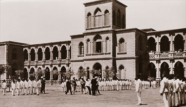Student inspection at Gordon College, Khartoum. Lines of Sudanese students, dressed in a uniform of