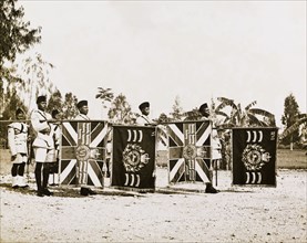 The Tanganyika Rifles present their colours. Soldiers of the Tanganyika Rifles present their