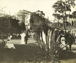 New Year's garden party at Government House, Perth. Guests stroll through the grounds of Government