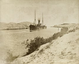 Ship in the Suez Canal, circa 1901. A steamship navigates its way through the Suez Canal. Suez,
