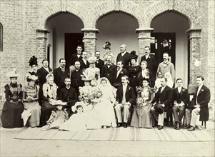 A British wedding in India, 1899. A newly-wed British couple pose for a group portrait with their