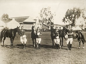 Polo players with their horses, Kenya. Four polo players, probably members of the Kenya Police