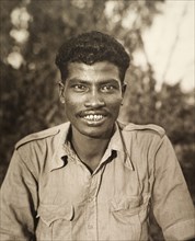Portrait of a 'shikari'. Portrait of a smiling 'shikari' (hunter), wearing a Western-style shirt.