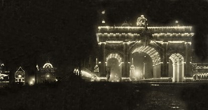 Illuminations for the royal visit, Melbourne. An archway is illuminated with lights, part of