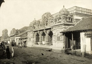 A Hindu temple in Colombo. A Hindu temple with an ornate, carved stone facade flanks a dirt road in