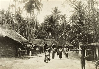Street scene in Ceylon. Street scene in Ceylon (Sri Lanka). Several people walk to and fro along a