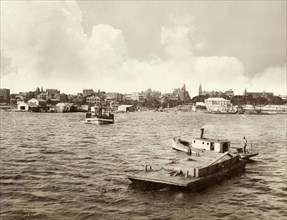 View of Perth from Swan River. View of Perth taken from Swan River, showing a number of tug boats