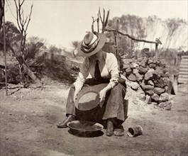 Lady Annie Lawley panning for gold. Lady Annie Lawley concentrates as she pans for gold. Probably