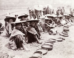 Mendicants beg by the roadside, China. A number of mendicants, some of whom are suffering from
