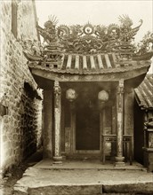 Ornate entrance to a Hong Kong Joss house. An ornate, pagoda-style roof, adorned with religious