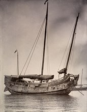 A Chinese junk at anchor. A Chinese junk, pictured at anchor with its sails rolled down. Hong Kong,