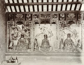 Deities inside a Chinese Joss house. Statues of Chinese deities ('Joss') line the walls inside a