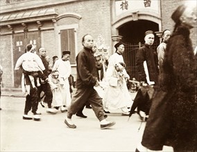 A wealthy Chinese funeral procession. Mourners at a wealthy Chinese funeral procession follow a
