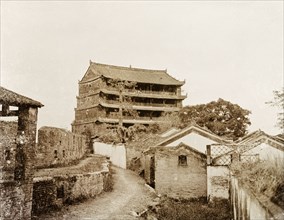 A five-storey pagoda in Canton. A five-storey pagoda stands beside the ruins of an old city wall.