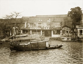 Riverside scene in Canton. Three sampans are moored at a riverside harbour. Canton, Canton Province