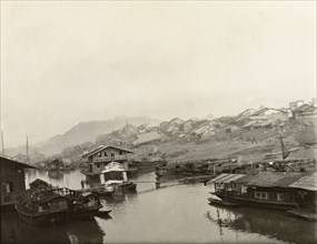 Houseboats at Wuchow. Several houseboats are moored along the banks of the Xijiang River at Wuchow