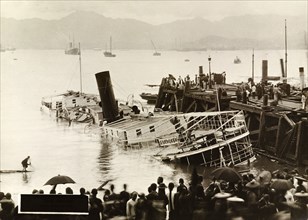 River steamer capsized by a typhoon. Wreck of the river steamer, 'San Cheong', after she was
