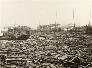 Typhoon devastation at East Point harbour. East Point harbour, swamped with debris and ship wrecks