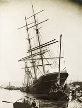 The 'Hitchcock' stricken by a typhoon. The 'Hitchcock', a large sailing ship, lies stricken on the