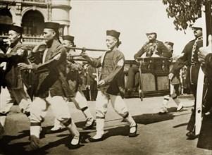 The Duke of Connaught visits Hong Kong, 1906. A team of Chinese bearers, wearing a uniform of