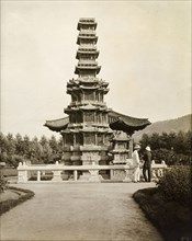 Pagoda-style monument in Seoul. Two European men chat together beneath an ornate pagoda-style