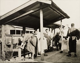 Freshening up at railway station in Manchuria. A group of Japanese travellers refresh themselves at