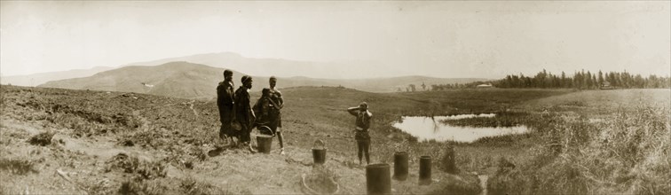 African women collecting water, South Africa. Five African women stand by pots placed on the