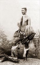 A Zulu warrior. Studio portrait of a Zulu warrior, dressed in traditional Zulu attire and holding a