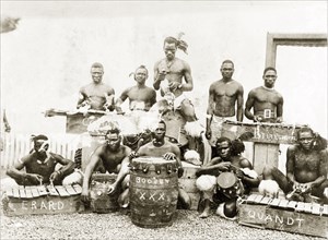 A Zulu percussion band. Group portrait of a Zulu percussion band posing by their drums and
