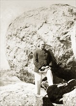 Cecil Rhodes at the Matopos Hills. Cecil Rhodes (1853-1902) stands amongst the granite boulders of