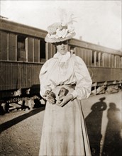 Mrs Pease with two bush owls . A woman identified as Mrs Pease stands beside a stationary railway