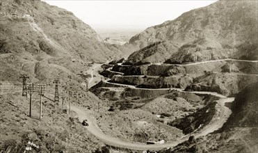View of the Khyber Pass. A motorcar travels along the winding Khyber Pass, a strategically