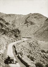 Near the site of Mollie Ellis' abduction. A motorcar pauses on a winding mountain road near the