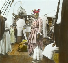 A female fruit vendor aboard the SS Chaleur. Portrait of a female fruit vendor aboard the SS