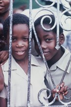 Two Jamaican schoolchildren. An official Jamaican Tourist Board photograph features two curious