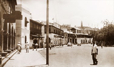 A street in Steamer Point, Aden. A line of buildings with open balconies flanks the main street