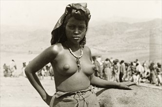 A young Eritean woman. Portrait of a young Eritean woman at a camel market. Naked from the waist