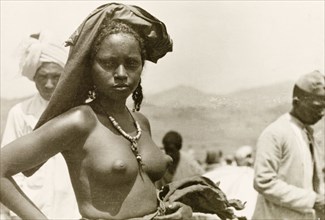 A young Eritean woman. Portrait of a young Eritean woman at a camel market. Naked from the waist
