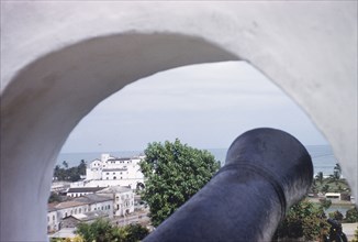 Elmina Castle from Fort St Jago. Distant view of Elmina Castle, taken through a cannon hole at Fort